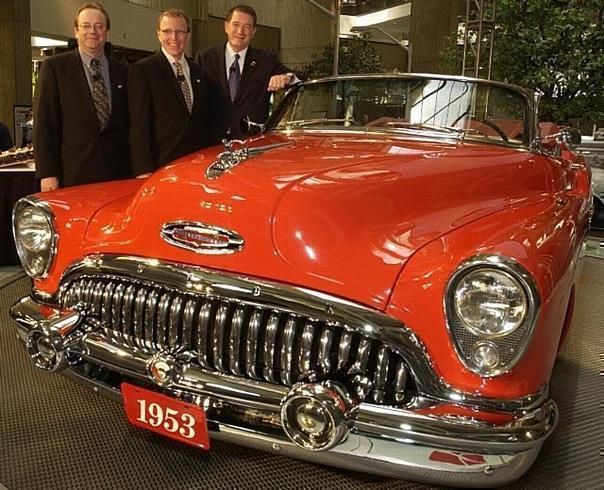 Buicks 100th birthday party in GM World Monday, May 19, 2003 as they pose with a 1953 Buick Roadmaster. 